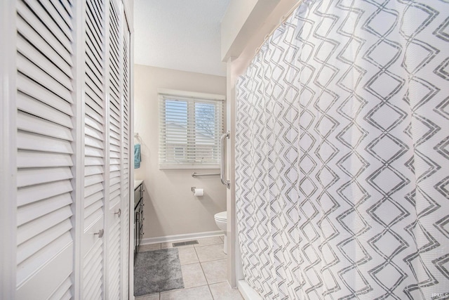 full bathroom featuring baseboards, visible vents, toilet, tile patterned floors, and a closet