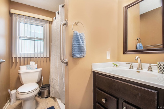 bathroom with tile patterned flooring, vanity, and toilet