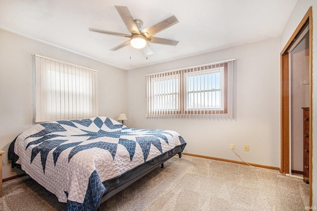 carpeted bedroom featuring a ceiling fan and baseboards