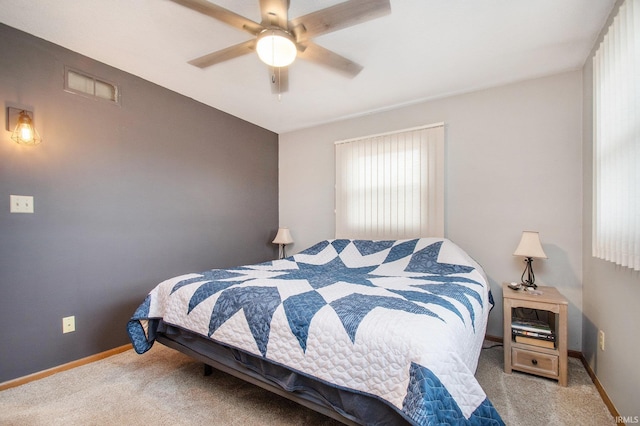 carpeted bedroom featuring visible vents, a ceiling fan, and baseboards