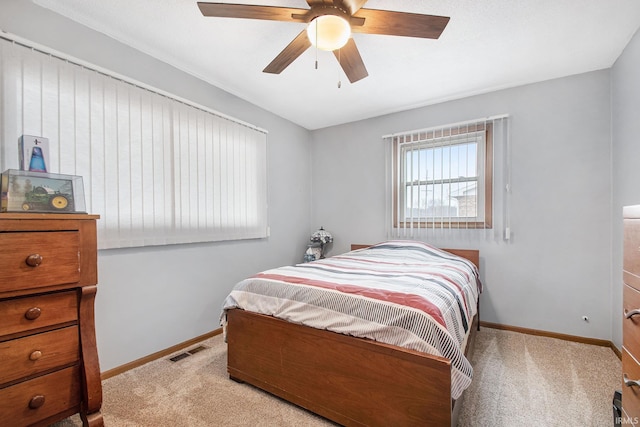 bedroom featuring ceiling fan, carpet floors, visible vents, and baseboards