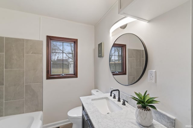 bathroom featuring baseboards, vanity, and toilet