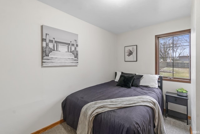 bedroom with carpet flooring and baseboards