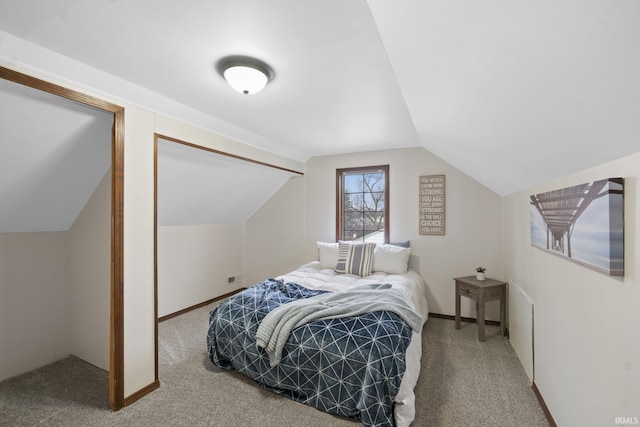 bedroom featuring vaulted ceiling, carpet, and baseboards