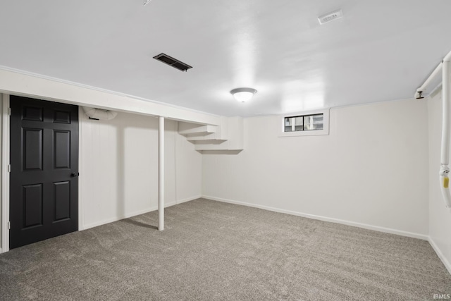 below grade area featuring carpet flooring, visible vents, and baseboards