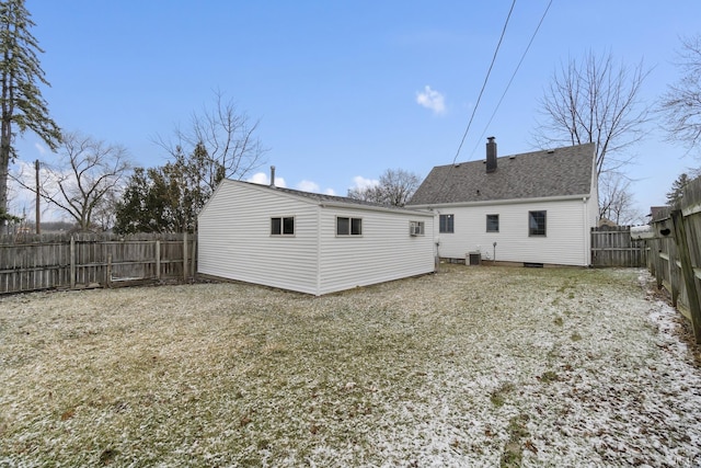 back of house with roof with shingles, a chimney, cooling unit, and a fenced backyard