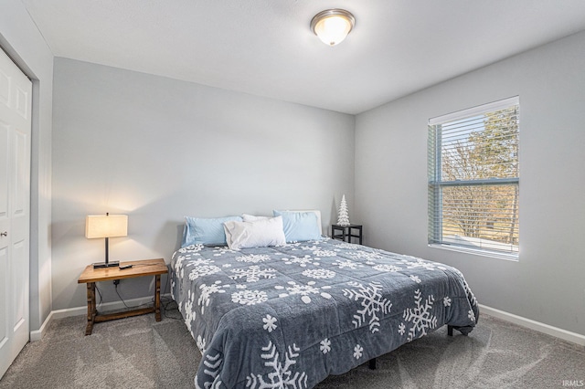 bedroom featuring carpet floors and baseboards