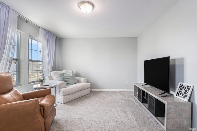 carpeted living room featuring baseboards