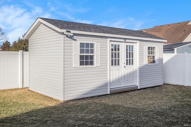 view of outdoor structure with a fenced backyard and an outdoor structure