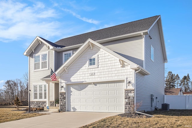 view of front of property with central AC unit, a garage, fence, stone siding, and concrete driveway