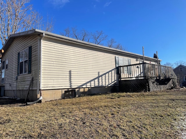 view of side of home featuring crawl space and a deck