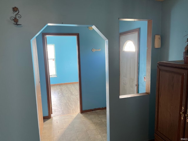 interior space featuring baseboards and light floors