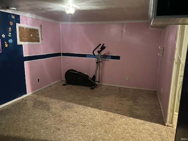 exercise area with baseboards and crown molding
