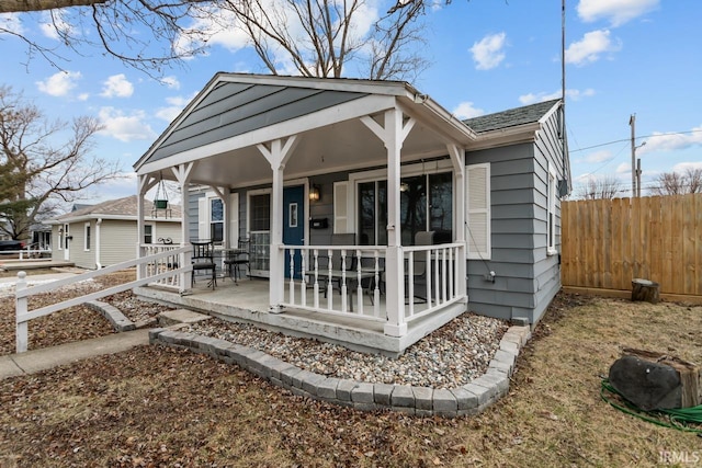 exterior space with covered porch and fence