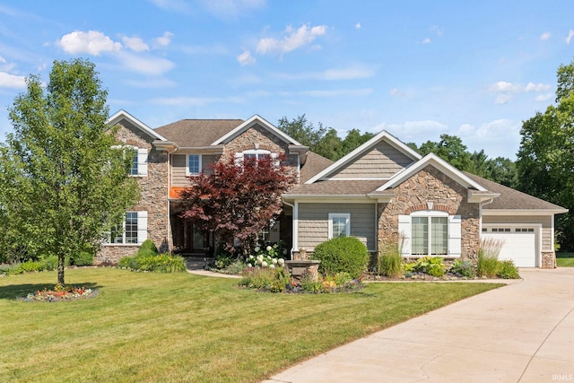 view of front facade with driveway, stone siding, an attached garage, and a front yard