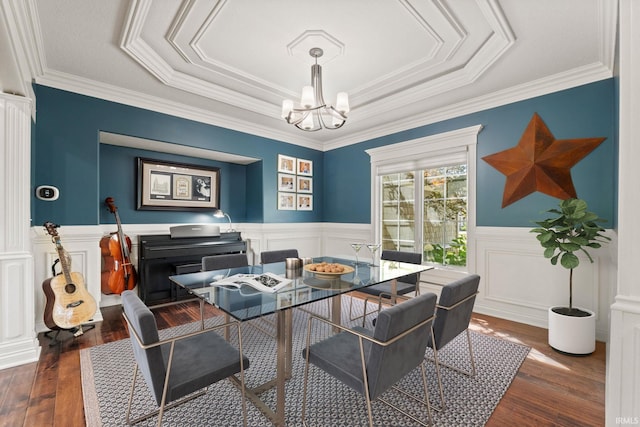 dining room featuring a chandelier, a wainscoted wall, and dark wood-type flooring