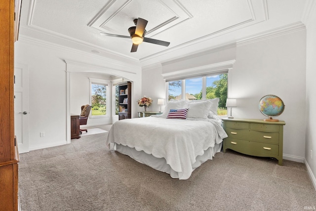 bedroom with baseboards, ornamental molding, a ceiling fan, and light colored carpet