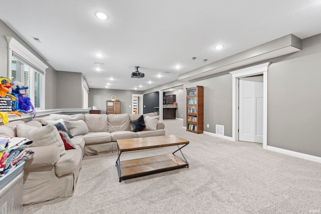 carpeted living room with baseboards, visible vents, and recessed lighting