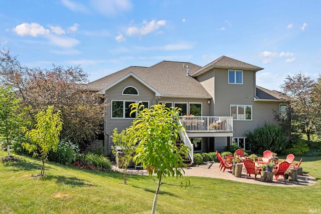 rear view of house featuring a yard, a wooden deck, stairs, and a patio