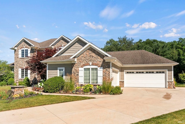 view of front of house with a garage, stone siding, a shingled roof, and concrete driveway