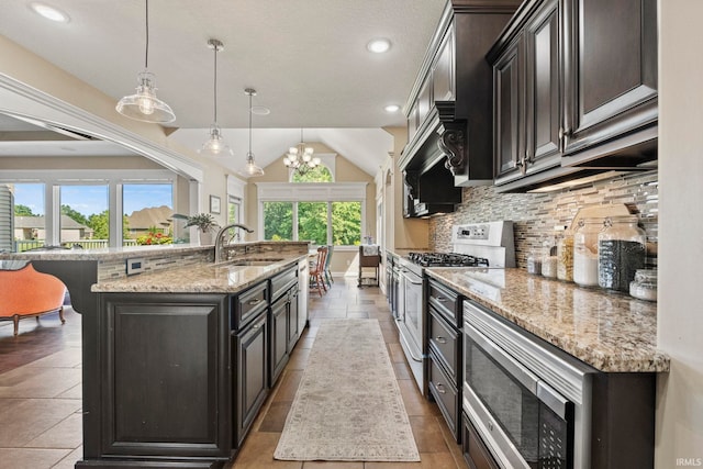 kitchen featuring stainless steel appliances, a healthy amount of sunlight, a sink, and backsplash