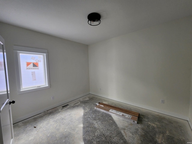 spare room featuring baseboards