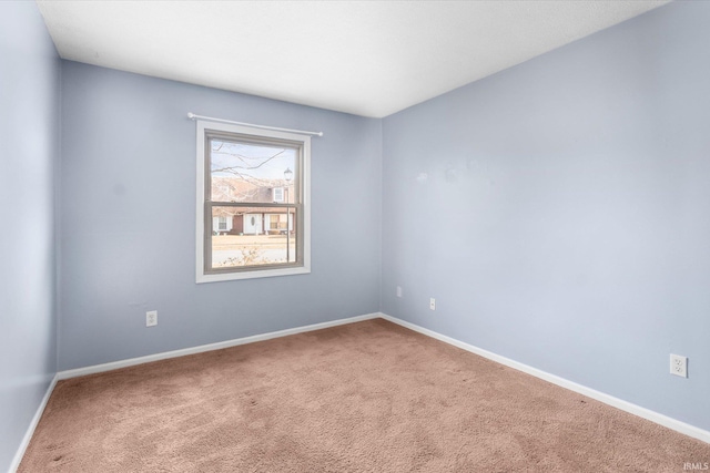 empty room with carpet floors and baseboards