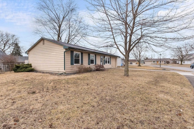 view of front of property with a front yard and fence