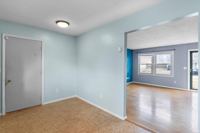 spare room featuring baseboards