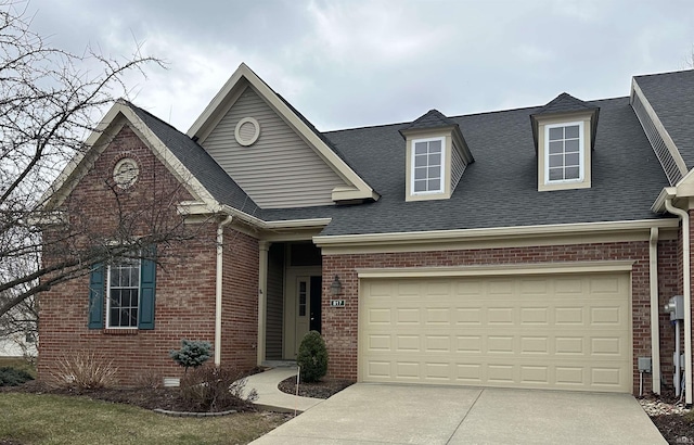 view of front of property with driveway, a shingled roof, and brick siding