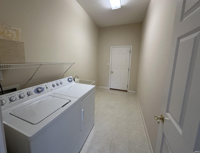 laundry room with laundry area, independent washer and dryer, and baseboards