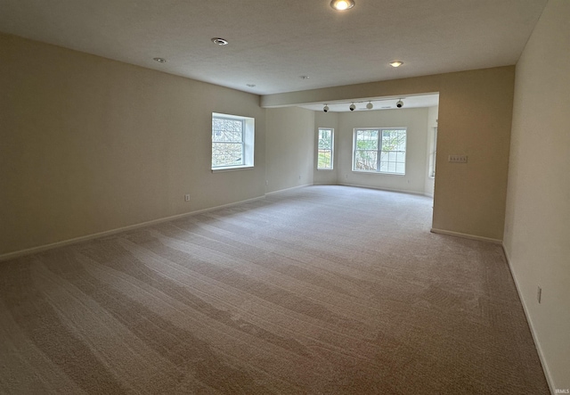 carpeted spare room with recessed lighting and baseboards