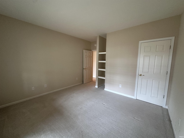 unfurnished bedroom with carpet and baseboards