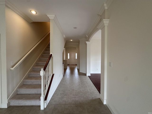 interior space with arched walkways, crown molding, and ornate columns