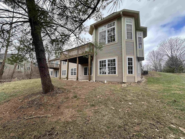 back of property featuring central AC, a yard, and a deck