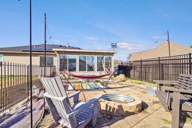 view of patio / terrace with a fenced backyard and a fire pit