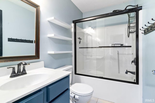 bathroom featuring vanity, tile patterned floors, toilet, and combined bath / shower with glass door