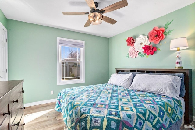 bedroom with baseboards, a ceiling fan, and light wood finished floors