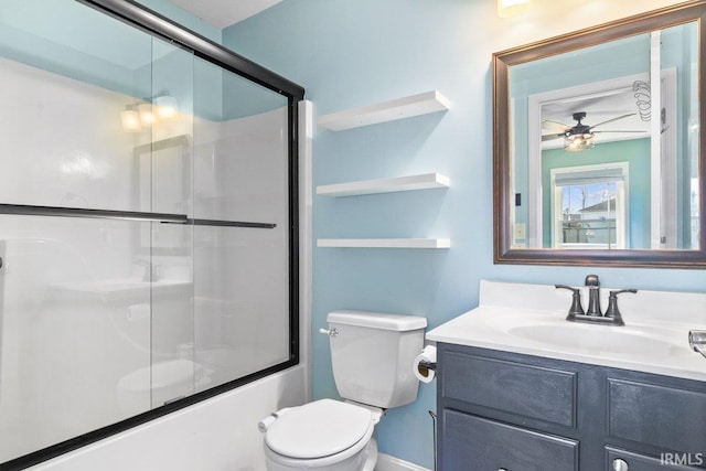 full bath featuring combined bath / shower with glass door, toilet, vanity, and ceiling fan