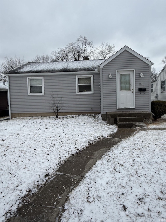 view of snow covered rear of property