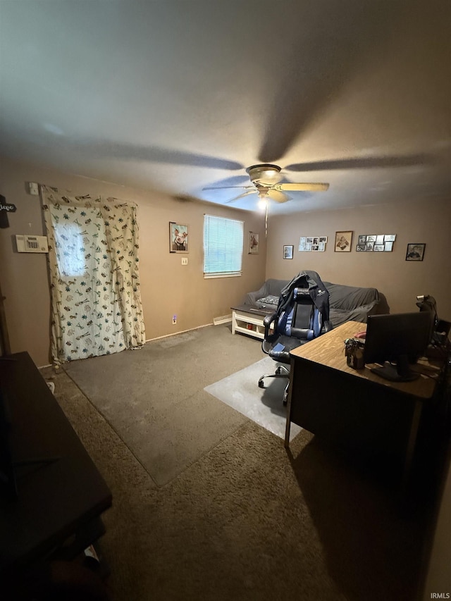 carpeted office space featuring a ceiling fan