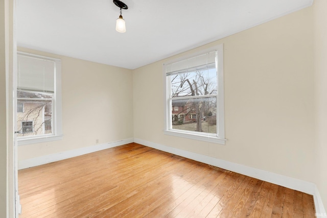 unfurnished room featuring light wood-style flooring and baseboards