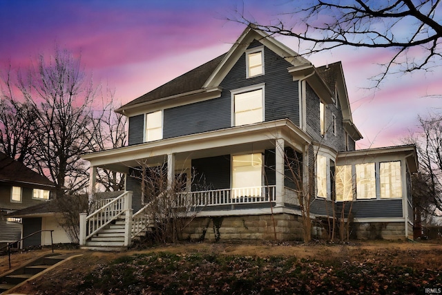 view of front of house with covered porch and stairway