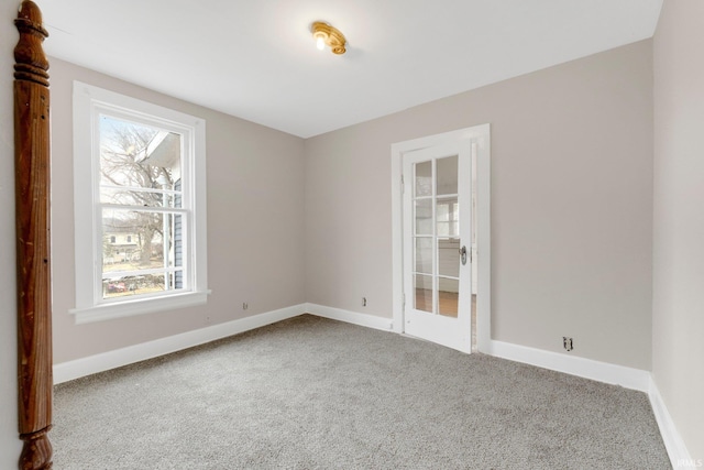 carpeted spare room with baseboards