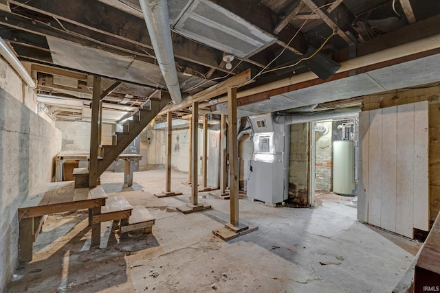 unfinished basement featuring water heater, stairway, and heating unit