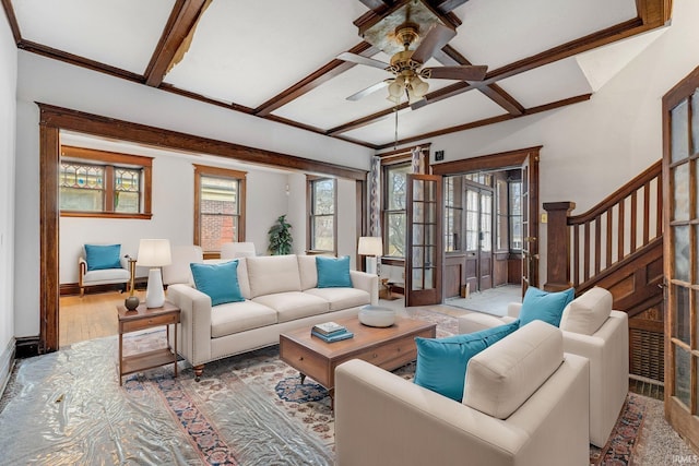 living room with ceiling fan, stairway, wood finished floors, french doors, and beam ceiling