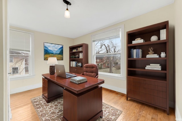 office area featuring light wood-style floors and baseboards