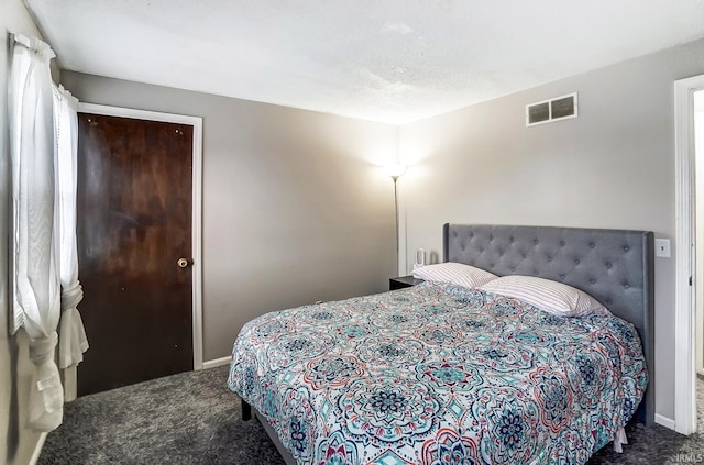 carpeted bedroom featuring baseboards and visible vents