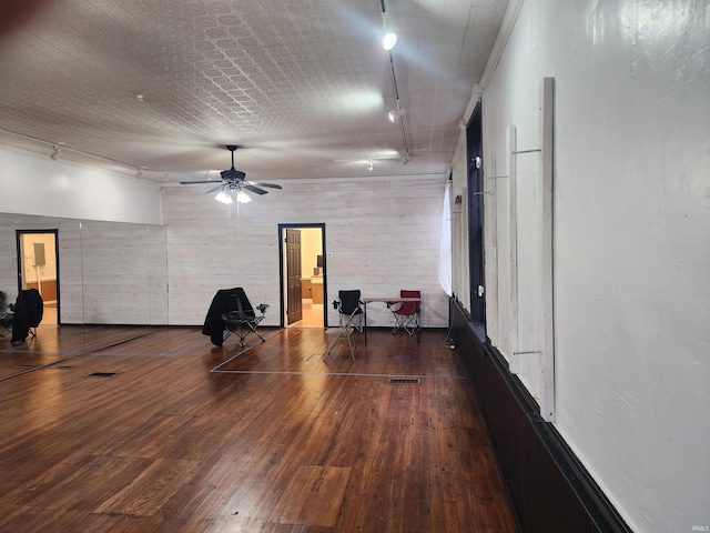 interior space featuring hardwood / wood-style floors, a ceiling fan, and track lighting