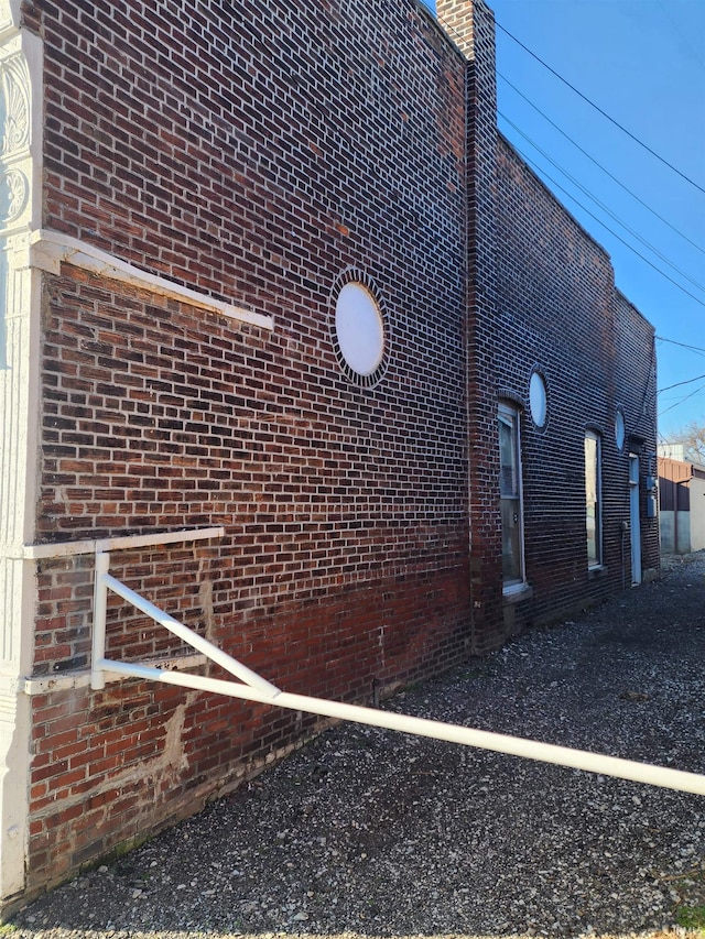 view of side of home featuring brick siding